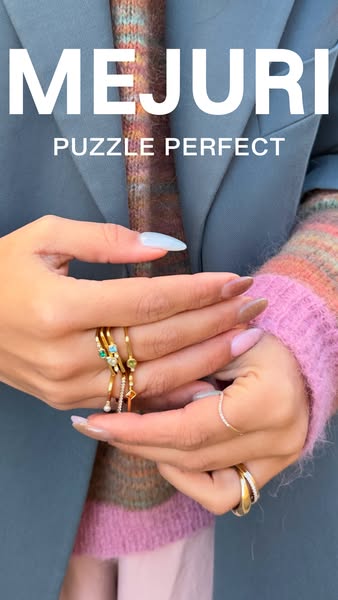 This image ad for Mejuri promotes their rings by displaying a woman's hands adorned with several gold rings. The ad 