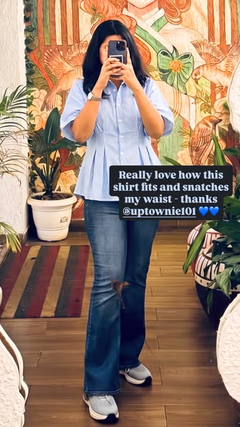 This ad features a woman who is taking a mirror selfie in a button-down shirt. The text overlay shares that she loves ho