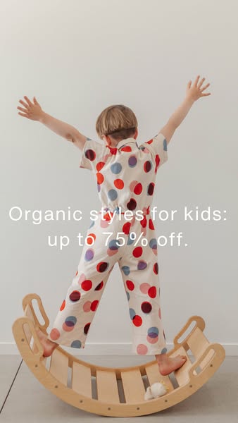 This image ad promotes organic kids' clothing with a discount of up to 75% off. The ad features a child in a polka-d