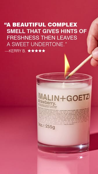 This ad features a quote from a customer about the scent of Malin+Goetz strawberry candle while a hand lights it with a 