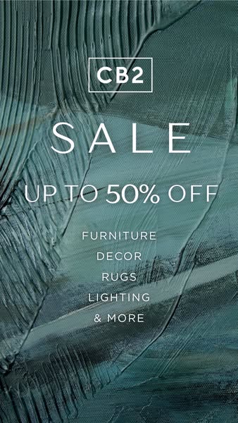 This is a sales promotion image ad by CB2. The ad announces a sale of up to 50% off on furniture, decor, rugs, lighting,