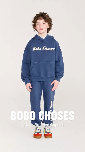 A young child models apparel from Bobo Choses' Branded Capsule collection.