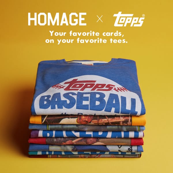 This image ad shows a stack of folded T-shirts with the Topps and Homage brand logos at the top of the image and copy th
