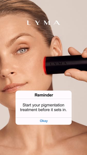 This ad features a woman using the LYMA laser on her face. An iOS reminder appears on the screen, prompting the viewer t