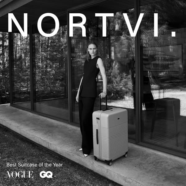 This ad features a woman standing next to a suitcase in front of a modern house. The ad highlights the brand's recog