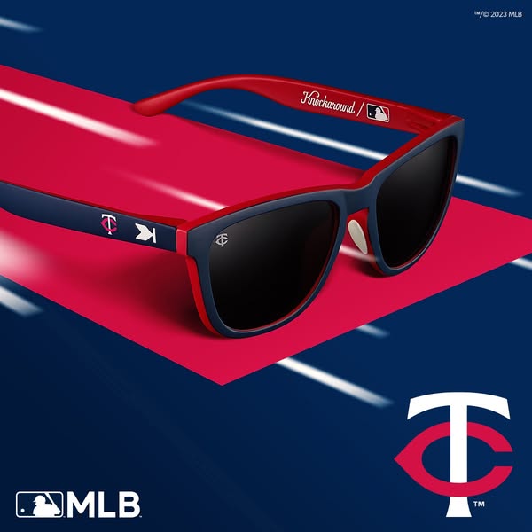 The ad showcases a pair of sunglasses with the Minnesota Twins logo on a red and blue background. The ad calls attention
