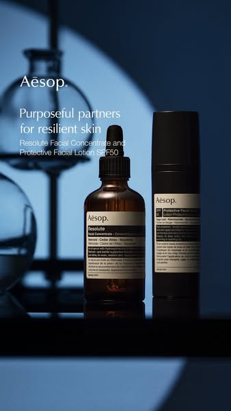 An image ad for Aesop skincare featuring their Resolute Facial Concentrate and Protective Facial Lotion SPF50. The ad us