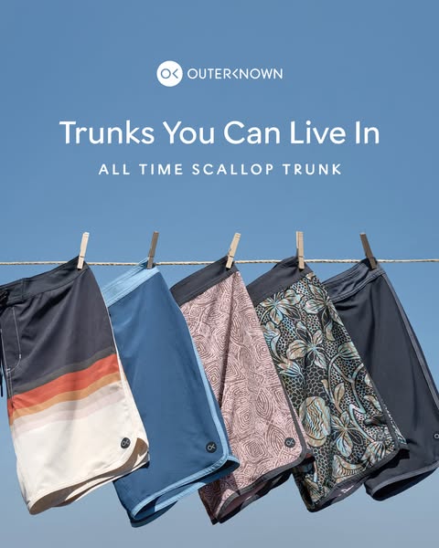This image ad shows five pairs of Outerknown All Time Scallop Trunks hanging on a clothesline against a bright blue sky.