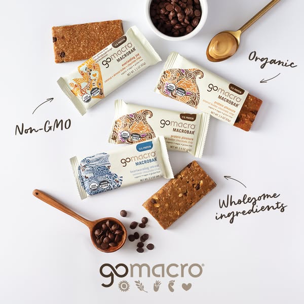 This image promotes GoMacro bars. The ad uses an overhead shot of several GoMacro bars, along with annotations that call