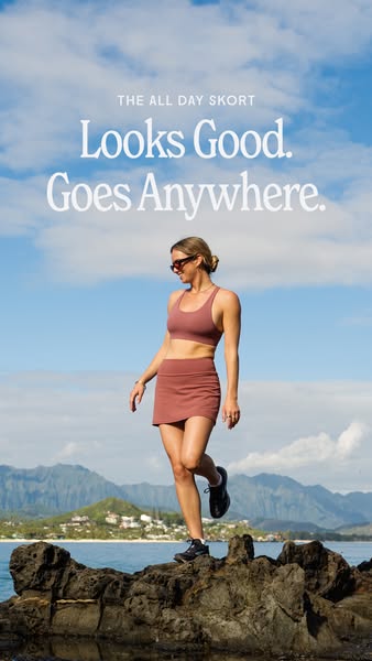 An image ad showcasing a woman in activewear standing on rocks near the ocean and mountains, wearing a matching athletic