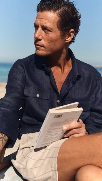 An image ad featuring a man on a beach, focused on the product.
