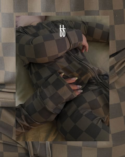 This ad features a close-up of a person wearing a brown and grey checkered, full body pajama onesie.