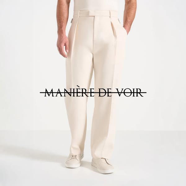 This ad showcases a pair of cream-colored dress pants from the brand Manière De Voir. It is a studio shot of the product