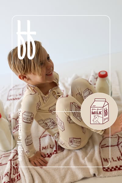 This ad features a toddler wearing pajamas with a milk carton print. A milk carton logo with the brand's initials is
