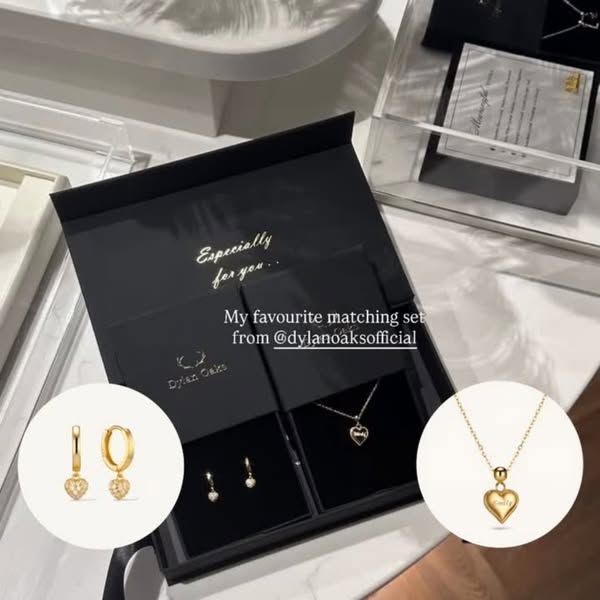 This ad showcases Dylan Oaks jewelry inside of its branded packaging. The image is from the perspective of someone who i