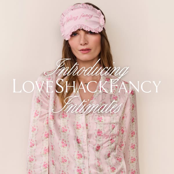 This image ad introduces LoveShackFancy Intimates, featuring a woman in pink floral pajamas and a matching eye mask.