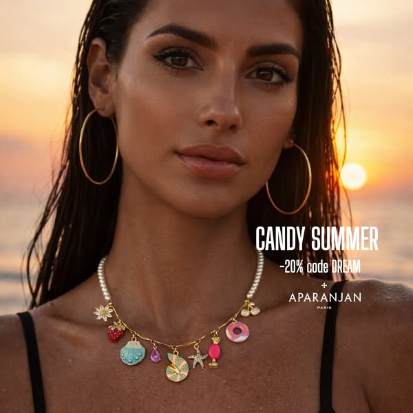 This image ad for Aparanjan Paris features a model wearing a charm necklace against a sunset beach background. The ad pr