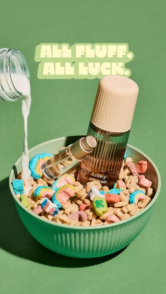This ad features perfume bottles in a bowl of Lucky Charms cereal. Milk is poured into the bowl while text reads, "