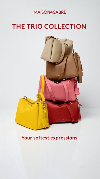 The image ad showcases Maison de Sabre's 'The Trio Collection,' featuring a stack of the brand's bags in