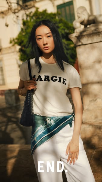 This ad features a model posing with a t-shirt that has the brand name printed on it. The ad shows the product and focus