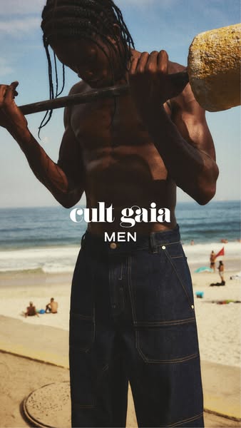 This ad features a shirtless man on a beach carrying a piece of concrete over his shoulder wearing blue jeans. The ad is