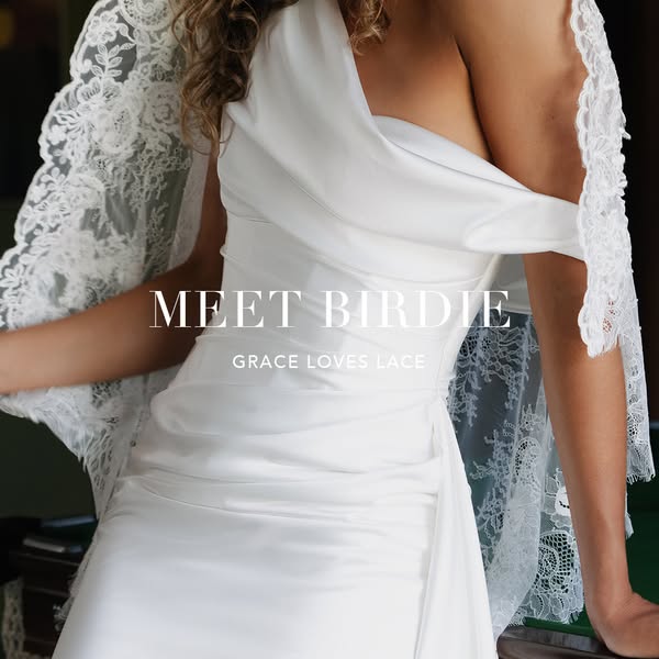This ad for Grace Loves Lace features one of their wedding dresses. The image highlights the dress and its lace shawl.