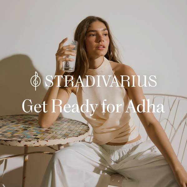 The ad features a model sitting at a table with a glass of water, wearing a pastel-colored top and pants, promoting STRA