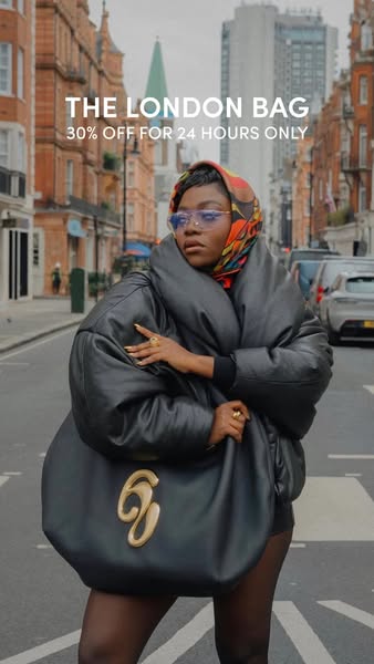 This ad showcases the London Bag, a black leather bag with a gold clasp. A woman poses with the bag in a street in Londo