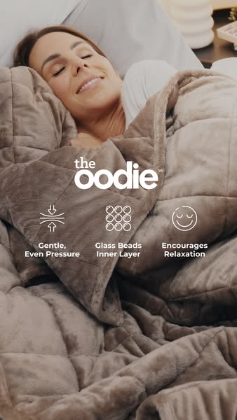 An image ad for The Oodie weighted blanket, showing a woman asleep and highlighting the product's features, like gen