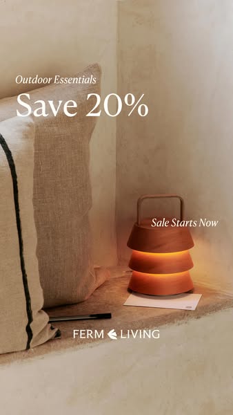 This Ferm Living ad features a warm and inviting ambiance, showcasing a decorative table lamp with a discount offer. The