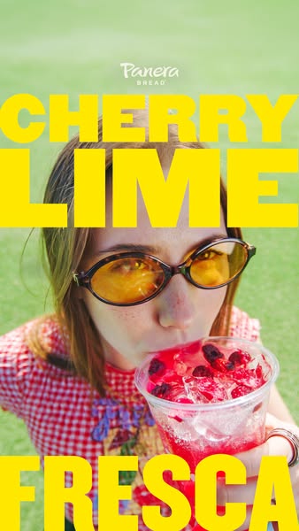 An image promoting Panera Bread's Cherry Lime Fresca. The background is an outdoor scene, with the drink overlaid wi