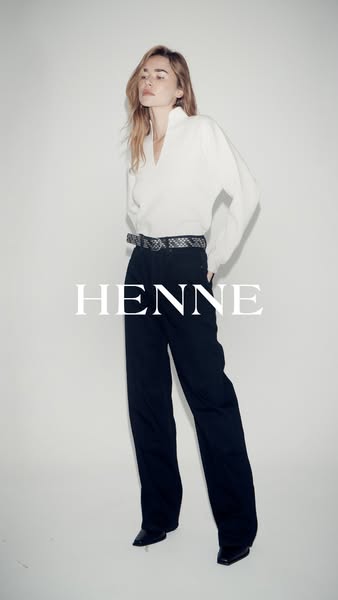A full-body shot of a model wearing Henne brand clothing.