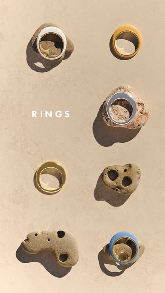This ad features rings from a jewelry brand. Each ring is placed on or next to a rock to create a natural, minimalist ae