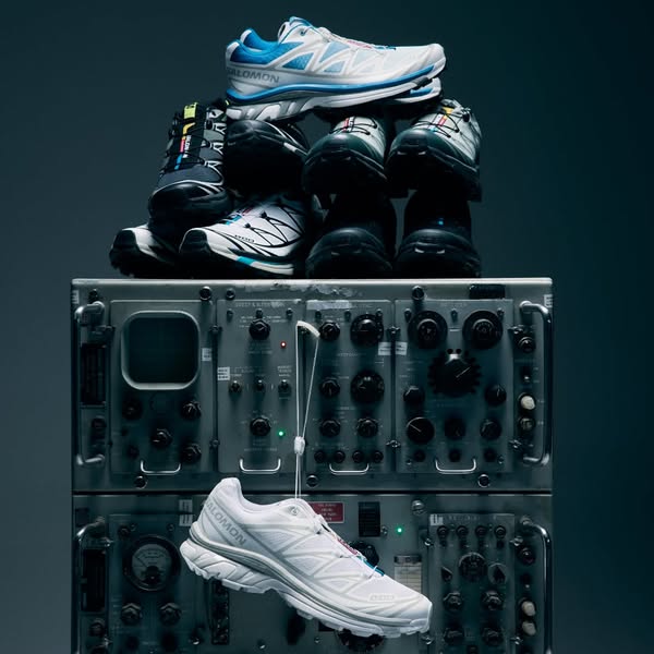 The ad is a product display showcasing the Salomon brand shoes that are stacked on top of a grey metal machine with mult