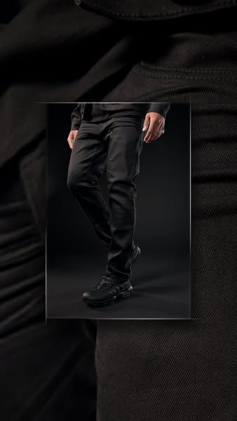 This ad showcases a pair of black pants being worn by a model. The ad focuses on the fit and style of the pants.