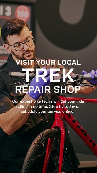 This image ad is for Trek bicycle repair shops. It shows a bike mechanic in the shop with a red Trek bicycle in the fore