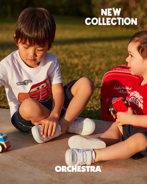 This ad is advertising a children's clothing brand called Orchestra. The visual features two toddlers on the ground,