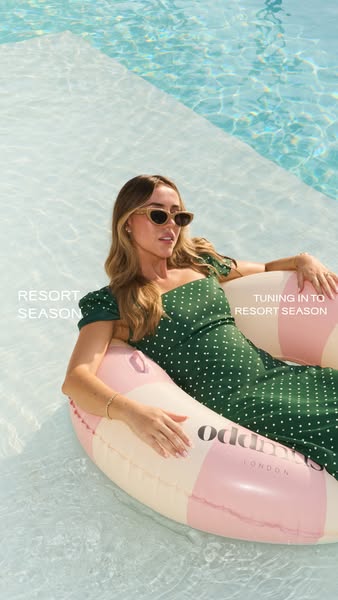 This image ad promotes Odd Muse clothing and shows a fair-skinned woman relaxing in a pool on a branded float, visually 