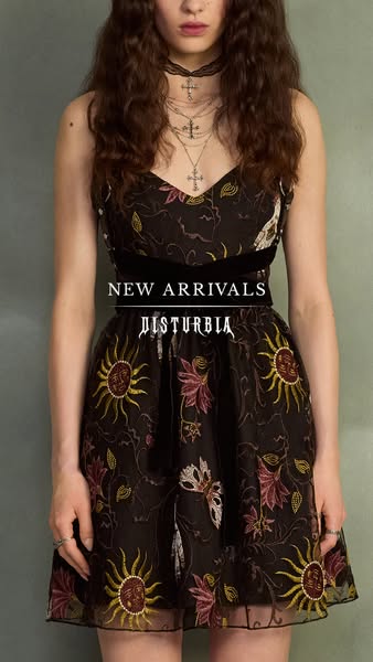 An advertisement for a black dress sold at Disturbia. The ad features a model wearing the dress against a grey wall.