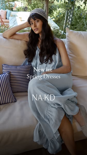 This image ad features a model wearing a blue dress from NA-KD's new Spring Dresses collection. The ad is designed t