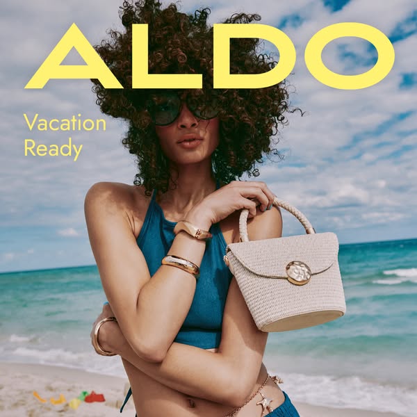 The ad showcases a woman on a beach, presenting the ALDO brand and a specific handbag as essential for a vacation-ready 
