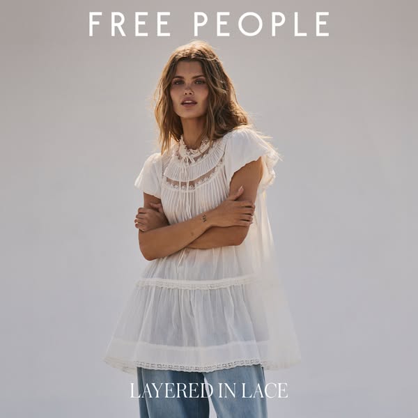 This Free People ad showcases a woman wearing a white, lace-layered top and jeans, emphasizing the brand's romantic 