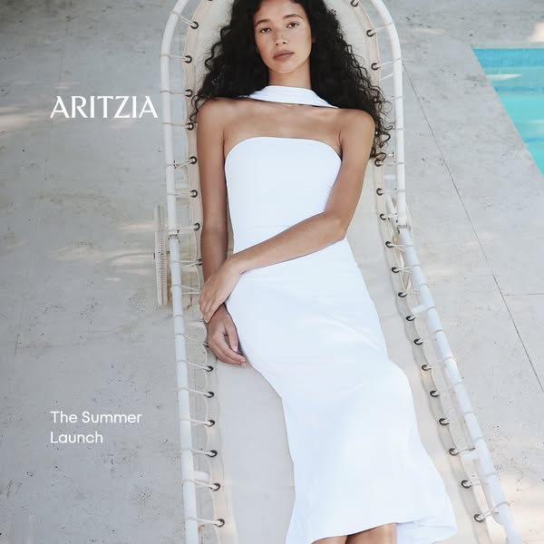 This ad promotes Aritzia's summer launch, featuring a woman lounging in a white dress. The overall aesthetic is clea