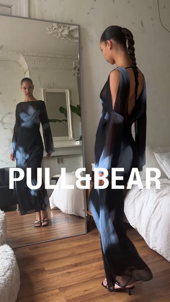 This ad features a model wearing a Pull&Bear dress and showcasing it in a full-length mirror. The mirror reflects th