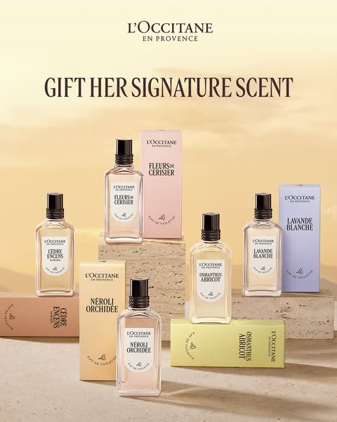 This image ad for L'Occitane En Provence features multiple bottles and boxes of their signature perfumes. The ad enc
