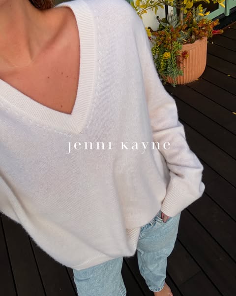 This image features a model wearing Jenni Kayne brand sweater in a relaxed setting, intended to highlight the quality an