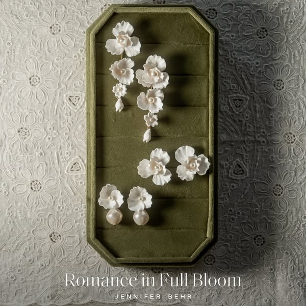 A jewelry ad that showcases a collection of Jennifer Behr earrings in an aesthetically pleasing way.