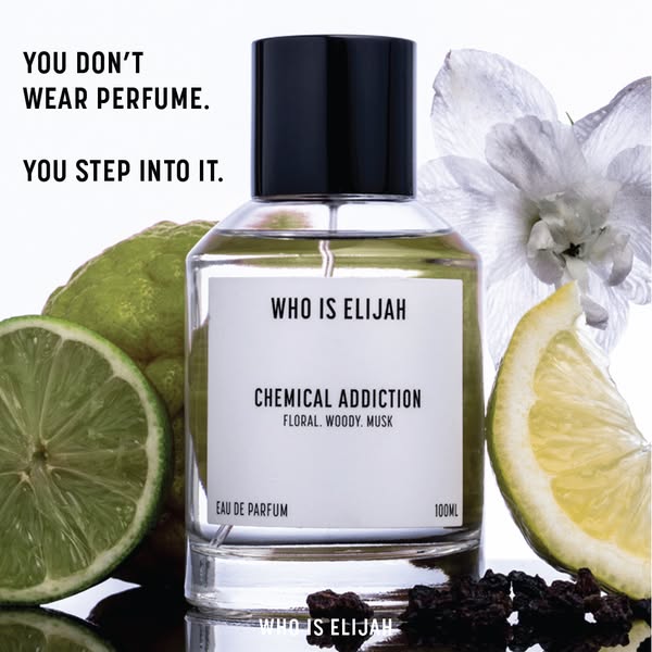 This image ad features a clear bottle of "WHO IS ELIJAH CHEMICAL ADDICTION" perfume surrounded by a sliced lim