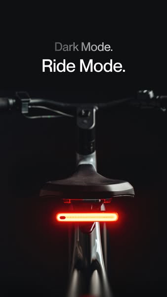 This ad features a sleek, black electric bike with a bright rear light, emphasizing its suitability for riding in dark c