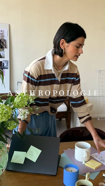 Anthroplogie image ad featuring a woman at her desk. She is wearing a tan striped shirt, and the ad is promoting the bra
